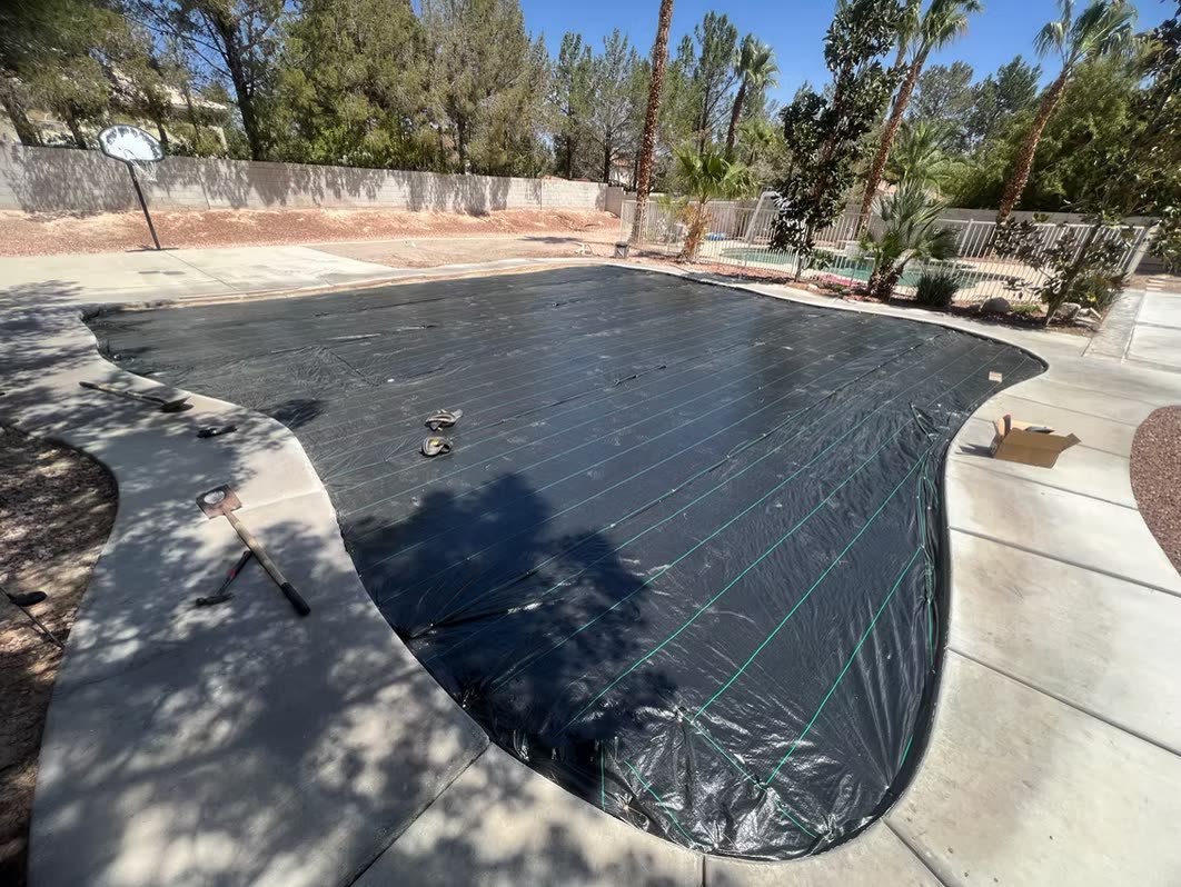 Yard prepped with weed barrier ahead of synthetic turf installation