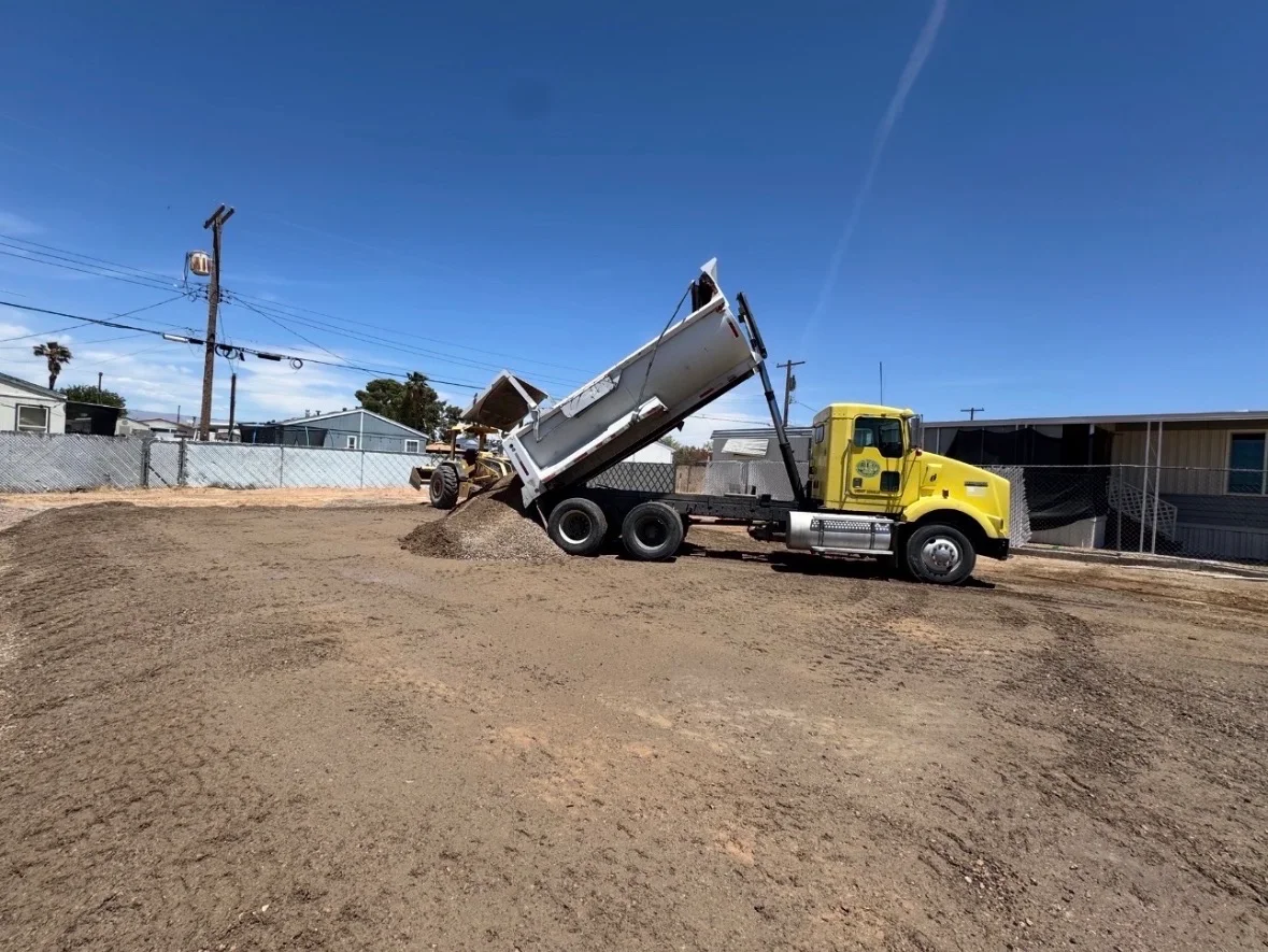 HTS Construction dump truck unloading gravel on a Las Vegas job site