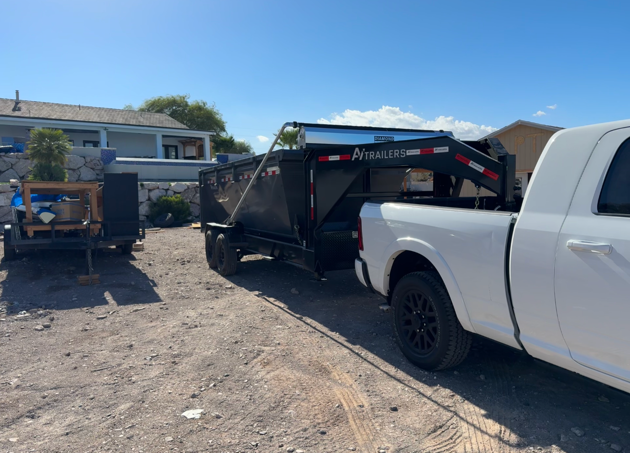 Dump trailer hooked to a pickup truck ready for a Las Vegas dumpster rental drop-off