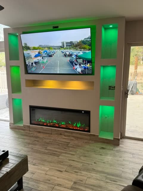 Custom built entertainment center with linear fireplace and accent lighting