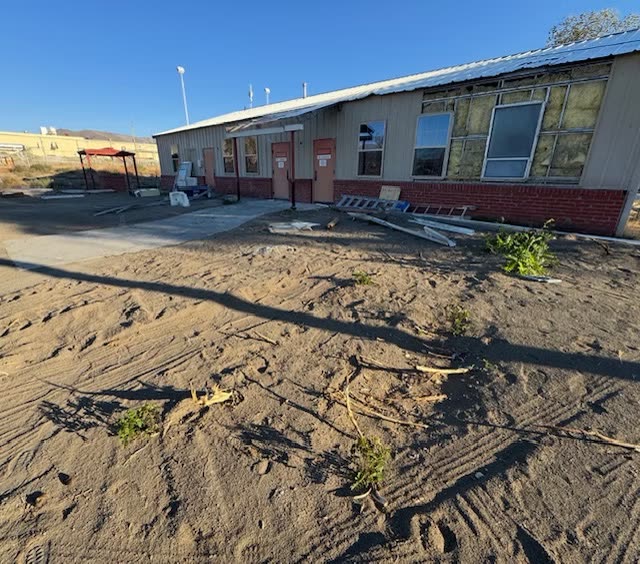 Commercial building entrance prepared for a retaining wall and paver renovation
